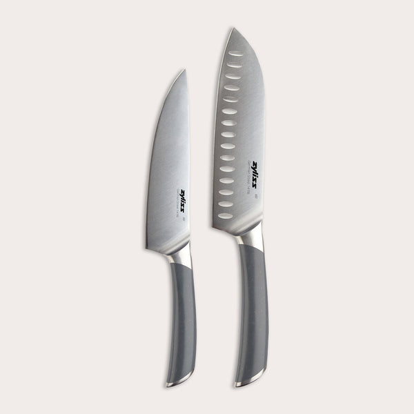 The Zyliss Comfort Pro Chef + Santoku Knife Set features two stainless steel kitchen knives with gray handles—a chef’s knife and a santoku knife—displayed side by side on a light background.