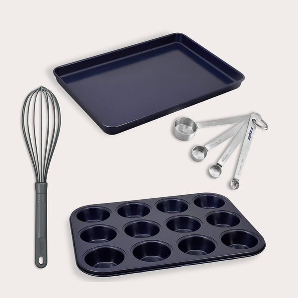 The Zyliss Baking Tools Bundle includes a flat non-stick baking tray, 12-cup muffin pan, metal whisk with black handle, and four measuring spoons—an ideal starter set for baking enthusiasts.