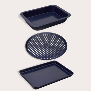 The Zyliss Baking Tray Bundle includes three dark blue carbon steel trays: a deep rectangular non-stick tray, a round perforated pizza pan, and a shallow sheet, all shown on a light background.